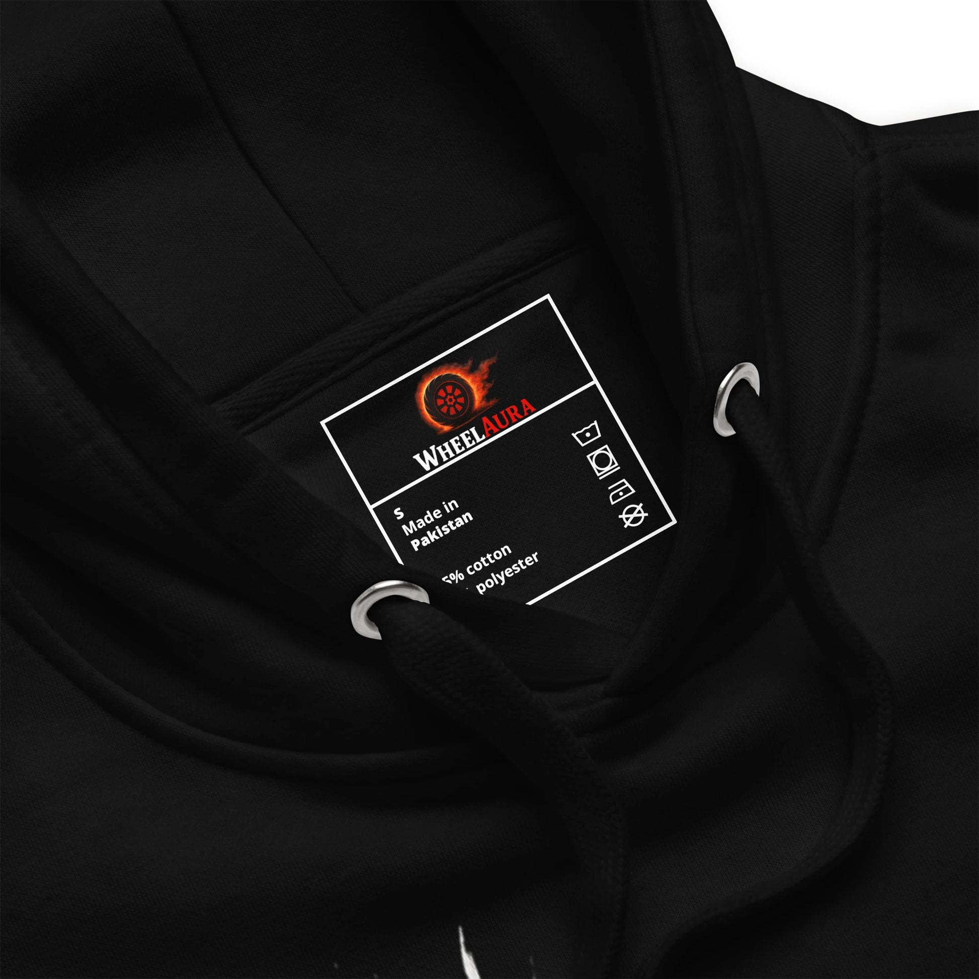Close-up of hoodie label inside the hood with WheelAura branding and care instructions.