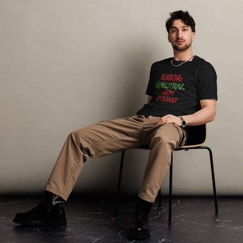 Man wearing black t-shirt sitting on chair, featuring red and green text that says 'Error: Neutral Not Found'.